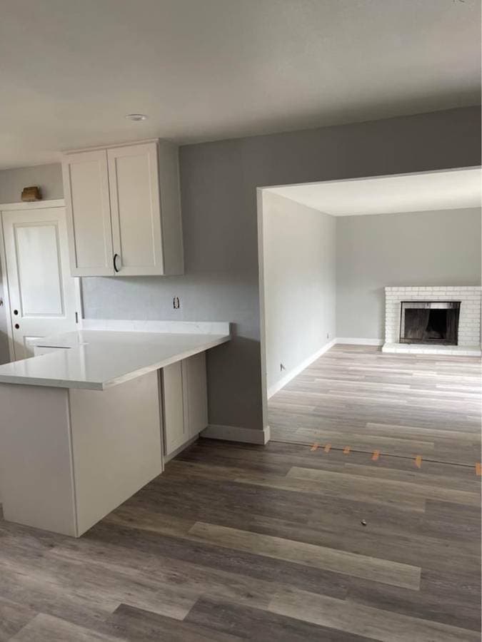 freshly installed gray laminate flooring and freshly painted living room walls